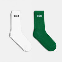 Duo de chaussettes éco-responsables en blanc et vert, pour un équilibre entre sobriété et nature.